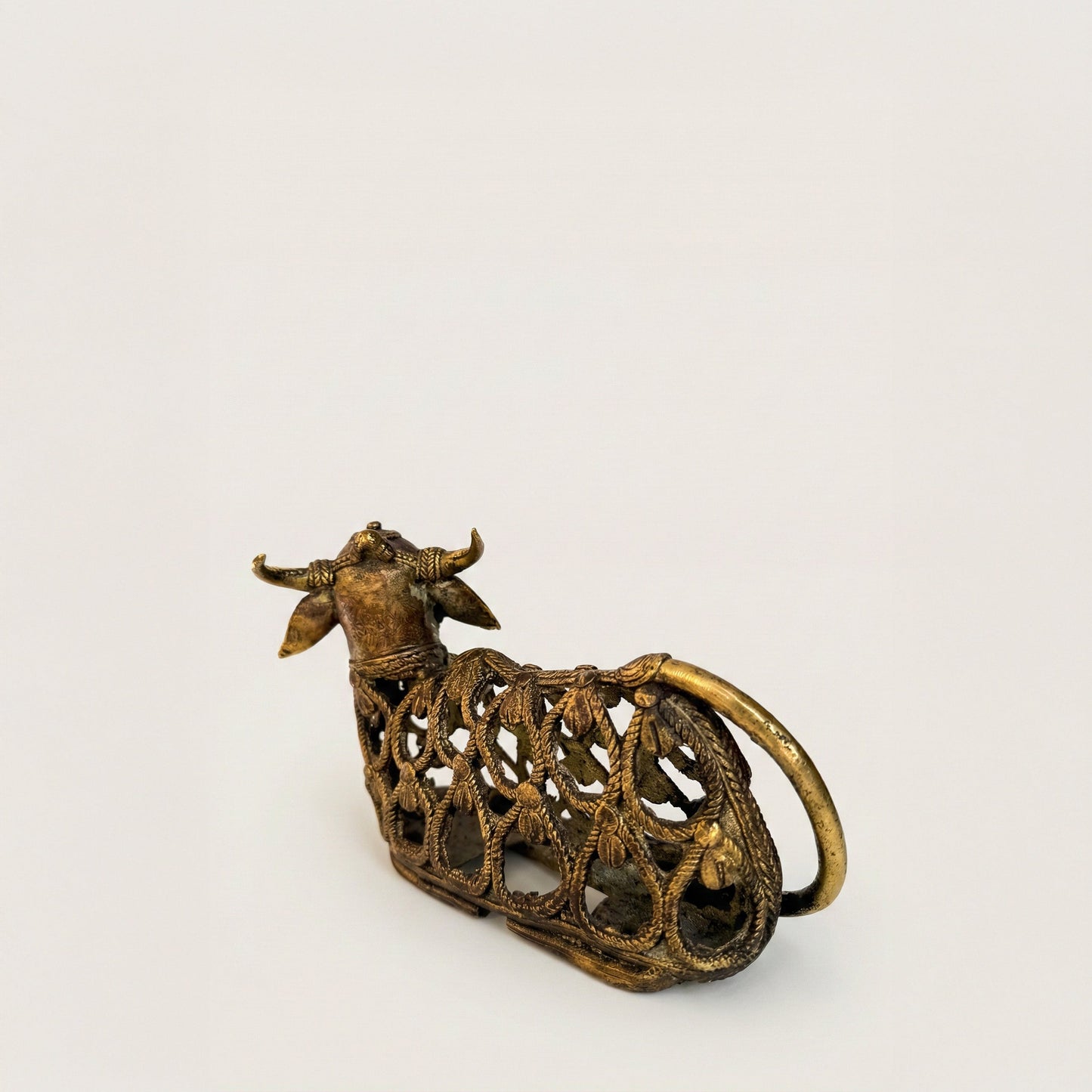 Close-up of Nandi Dhokra bull showing raised pellets, spiral lines, and latticework from lost-wax casting process