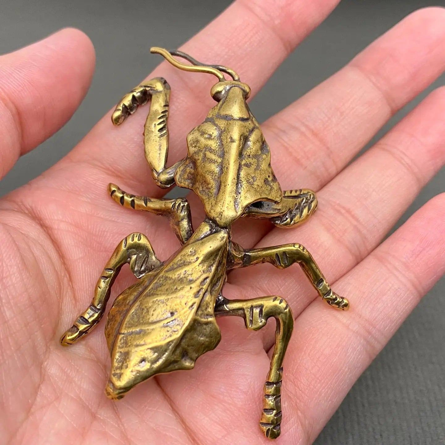 The Sovereign Stalk miniature brass mantis king in upright pose with raised forelegs and warm aged patina, from the WILLAGE Tiny Objects collection