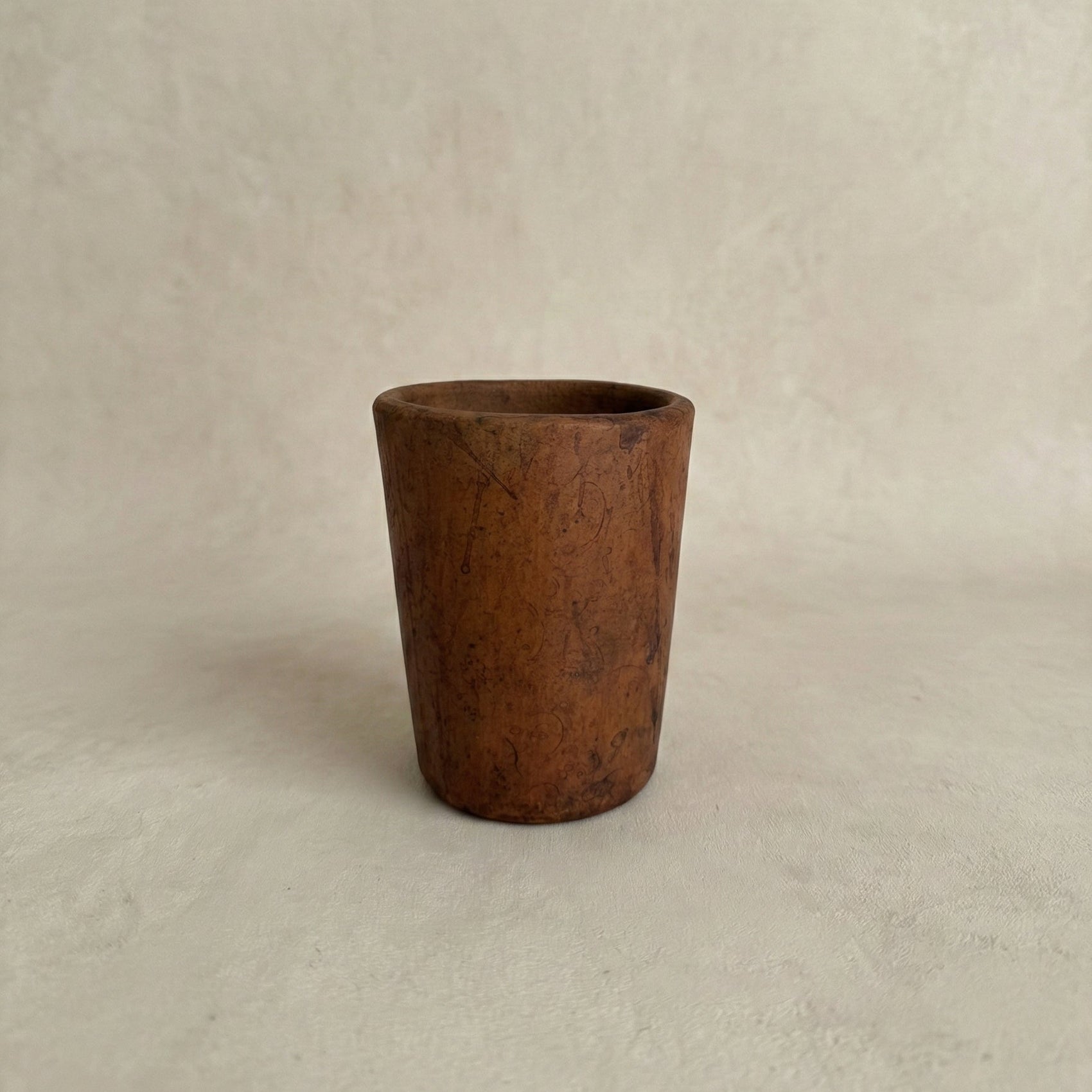 Sung Cup handleless black clay tumbler showing tapered form and natural tonal variation from fire, Lyrnai pottery from Meghalaya India, from WILLAGE