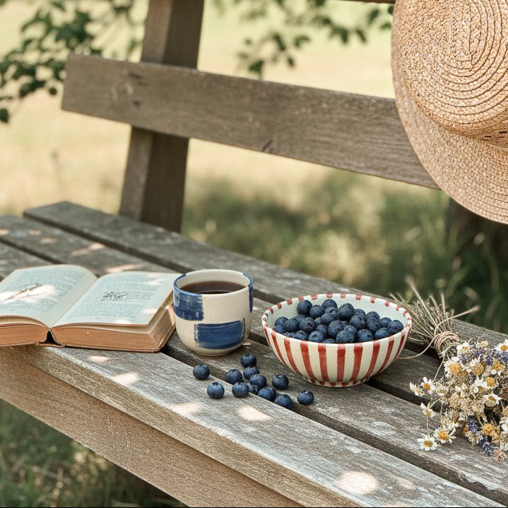 red ceramic bowl with red stripes , hand painted