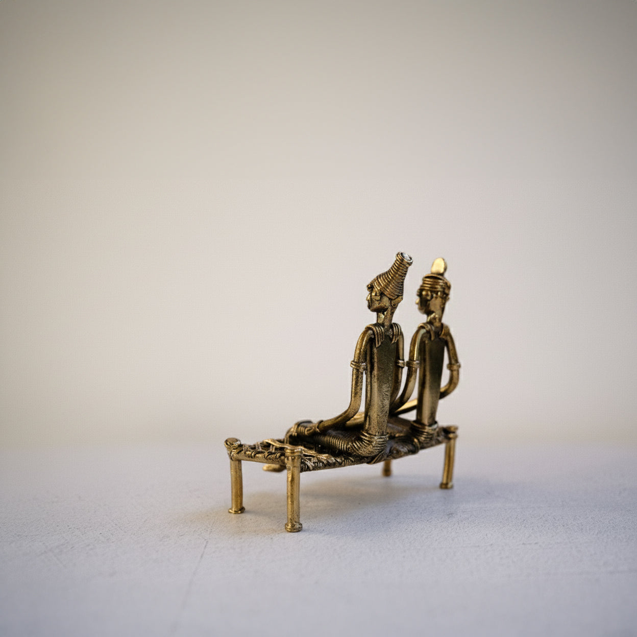 Close-up of The Seated Companions showing Dhokra lost-wax casting detail and elongated figurative forms
