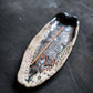 Latvian handcrafted incense dish with organic texture and incense stick