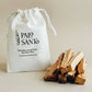 Palo Santo wood pieces with a branded drawstring bag on a beige background