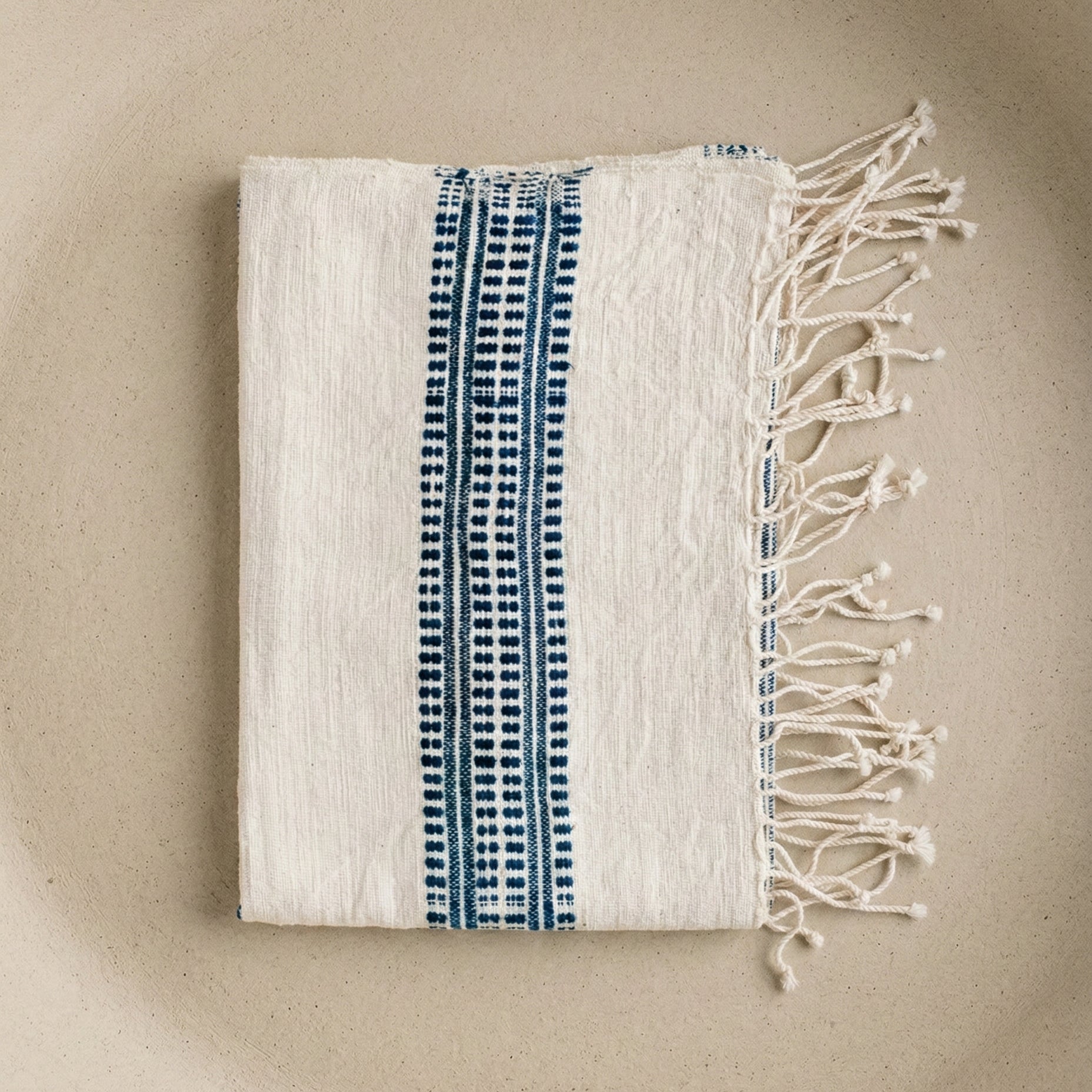 The Aden hand towel showing close-up of hand-spun cotton texture and navy woven stripes against a neutral background