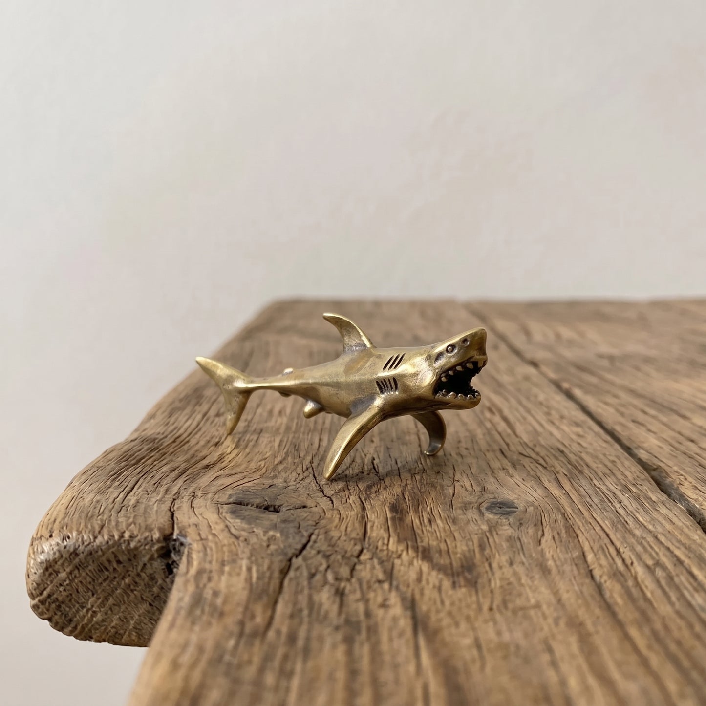 The Apex miniature solid brass shark figurine posed mid-swim with open jaw and aged antique patina