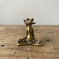 Close-up of The Balanced Warrior brass frog showing hand-cast surface detail and seated warrior pose