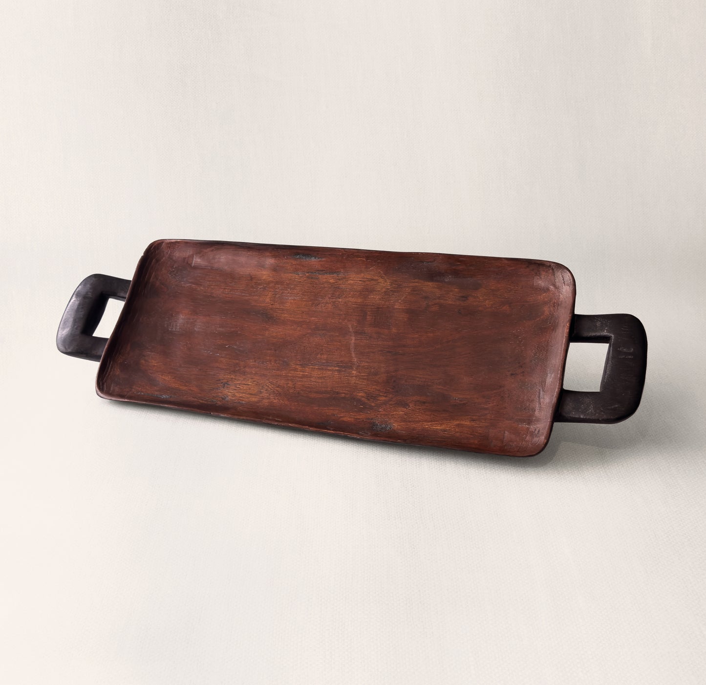 Close-up of hand-carved wooden handle on Bamenda serving tray, solid African hardwood from Togu'na