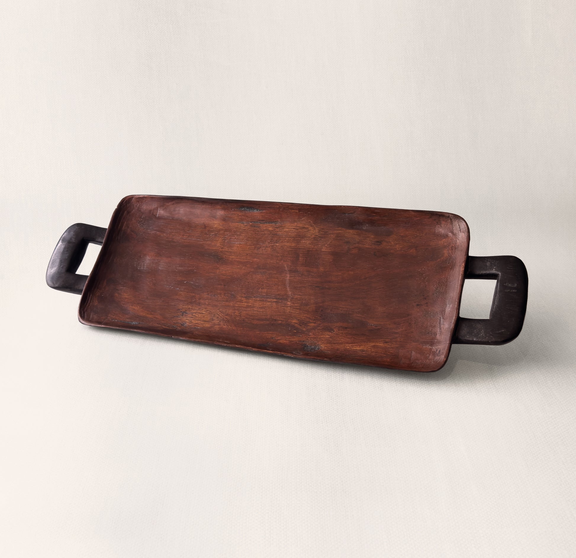 Close-up of hand-carved wooden handle on Bamenda serving tray, solid African hardwood from Togu'na