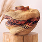 Bolgawoven elephant grass basket shown from alternate angle, showing organic woven form and natural dye pattern