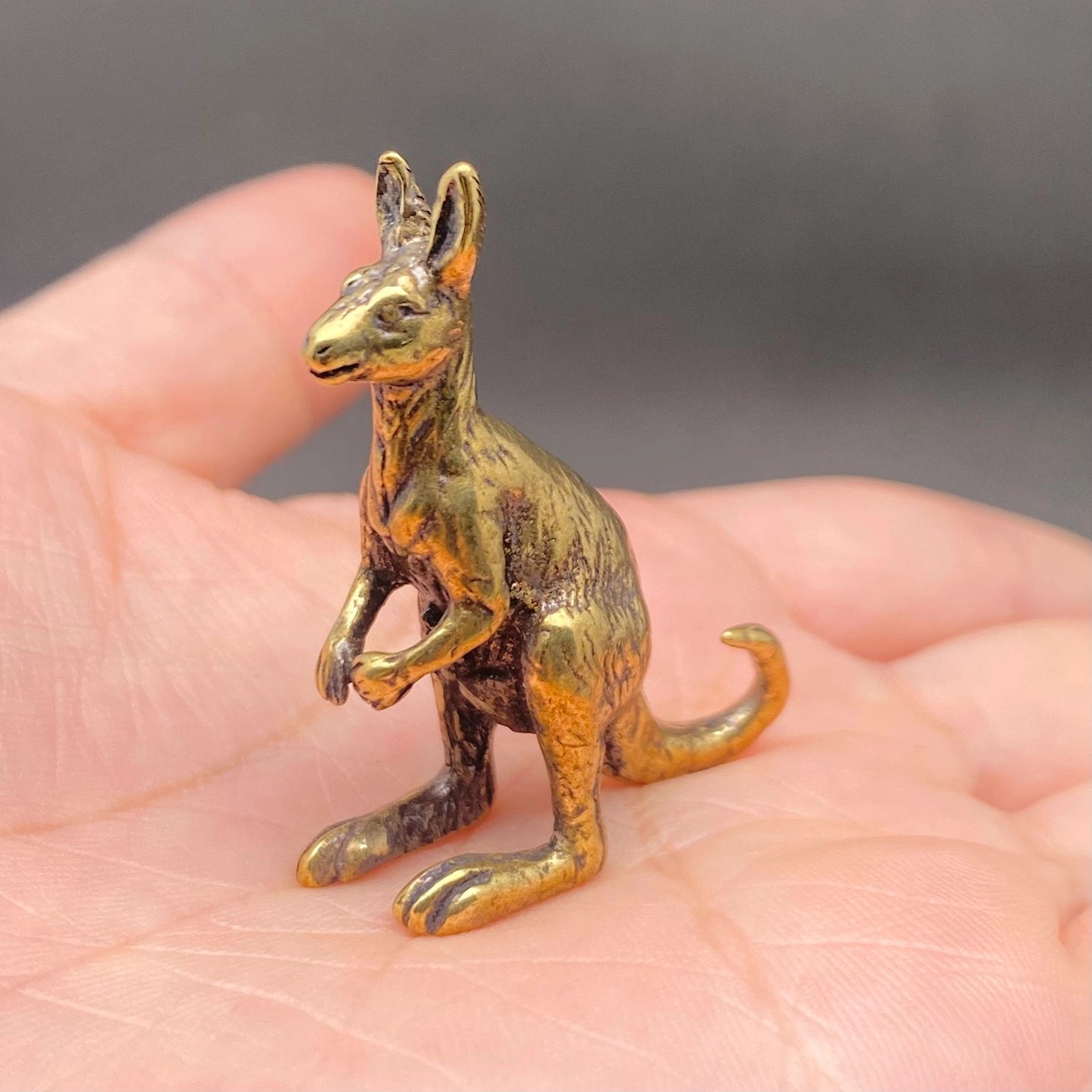 The Boundless Adventurer miniature brass kangaroo showing side profile and golden patina against a neutral background