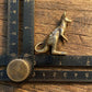 The Boundless Adventurer miniature brass kangaroo held in hand to show scale, with detailed ears and tail