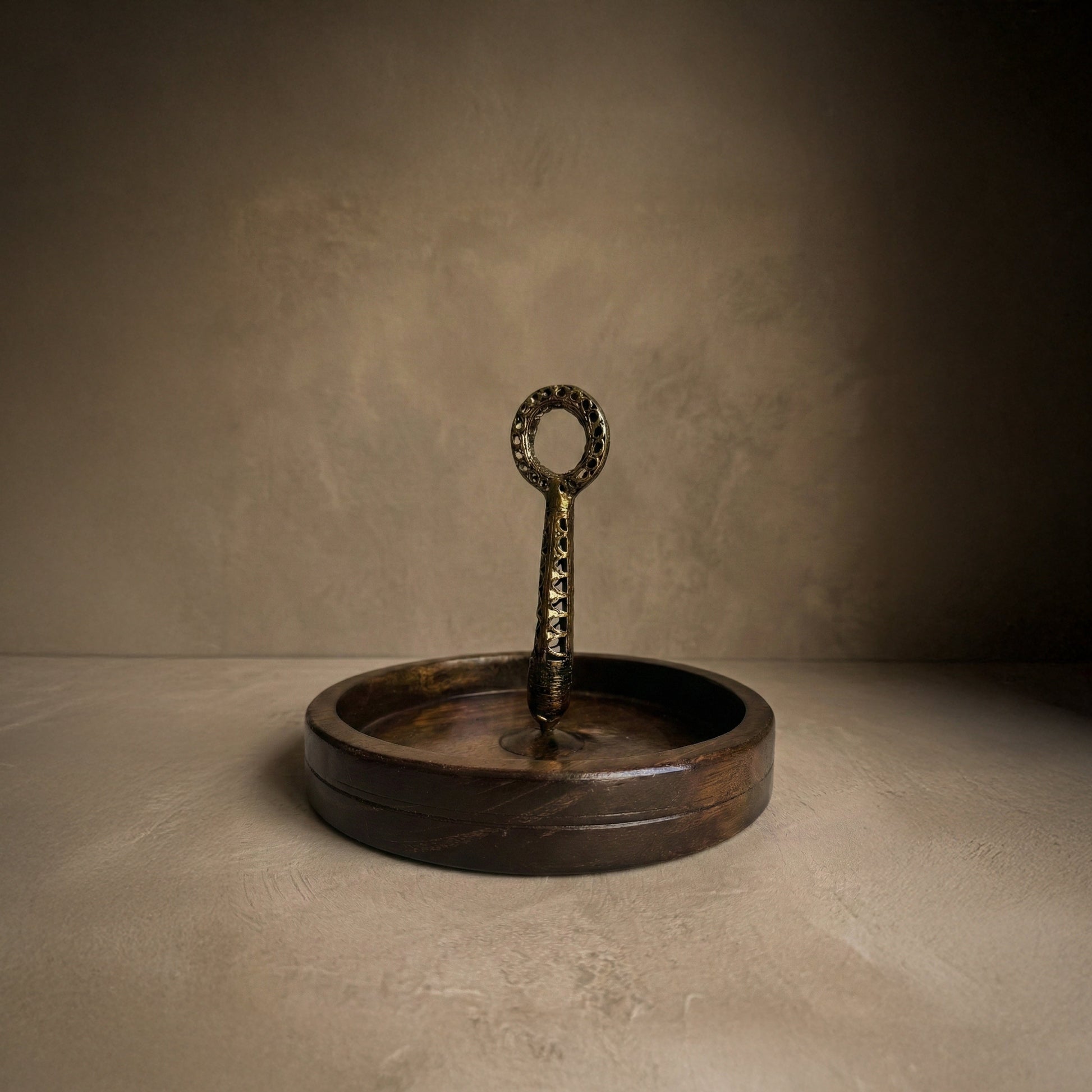 Close-up of Dhokra brass handle on The Brass Hold serving board showing lost-wax casting texture