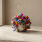 Hand-felted rainbow hedgehog soft toy with multicolored wool spines and a grey felt face, made in Nepal
