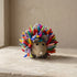 Hand-felted rainbow hedgehog soft toy with multicolored wool spines and a grey felt face, made in Nepal
