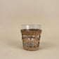 The Cỏ Tumblers recycled glass tumblers with hand-woven seagrass sleeves displayed on a wooden surface, crafted in Vietnam, from WILLAGE