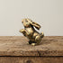 The Curious Sentinel miniature brass standing bunny on a wooden surface, upright on hind legs with ears raised and warm aged patina, from the WILLAGE Tiny Objects collection