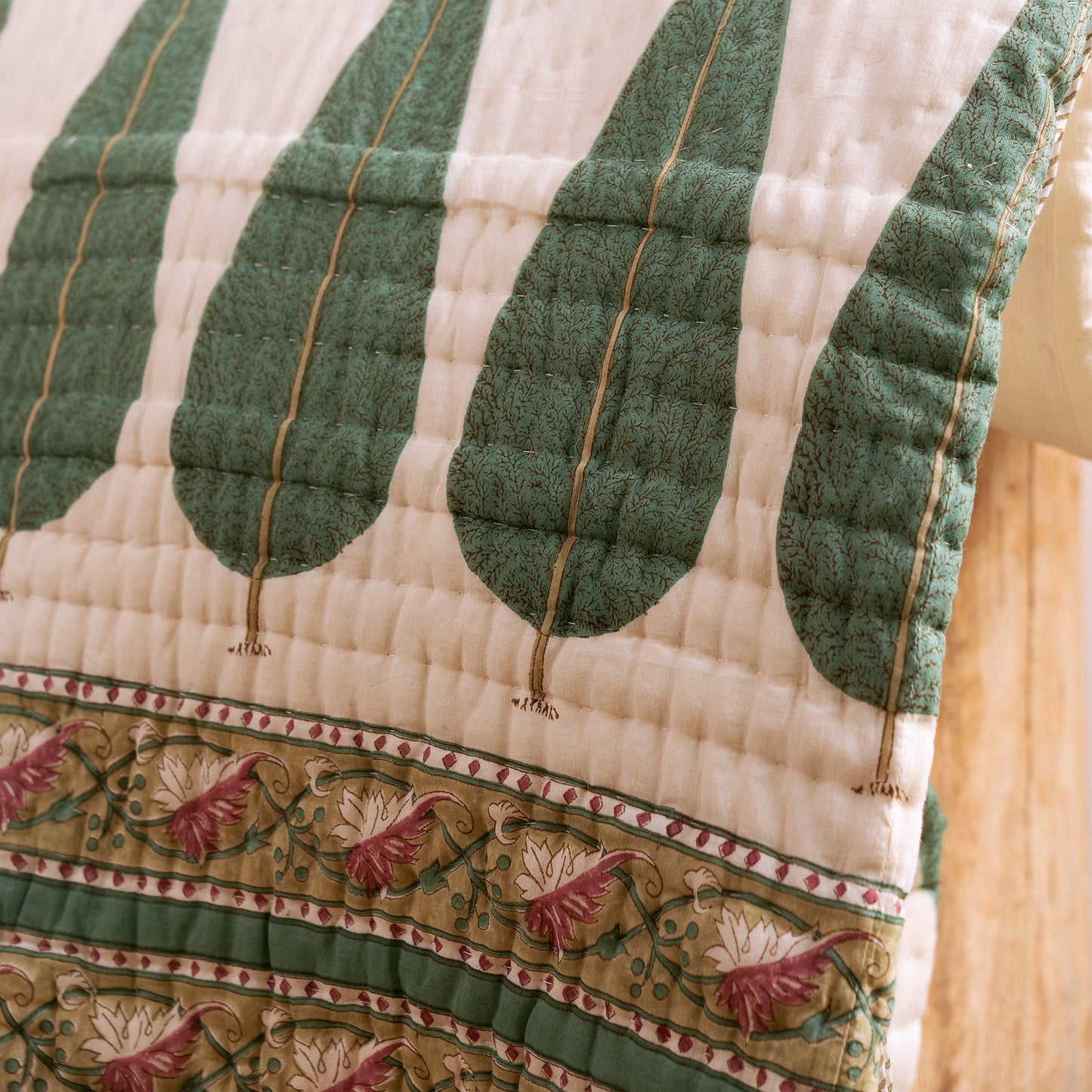 Hand block-printed cypress leaf motif on cotton voile quilt, showing artisan stitching, from WILLAGE