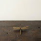 Close-up of The Dragonfly brass figurine showing wing vein detail and hand-cast texture
