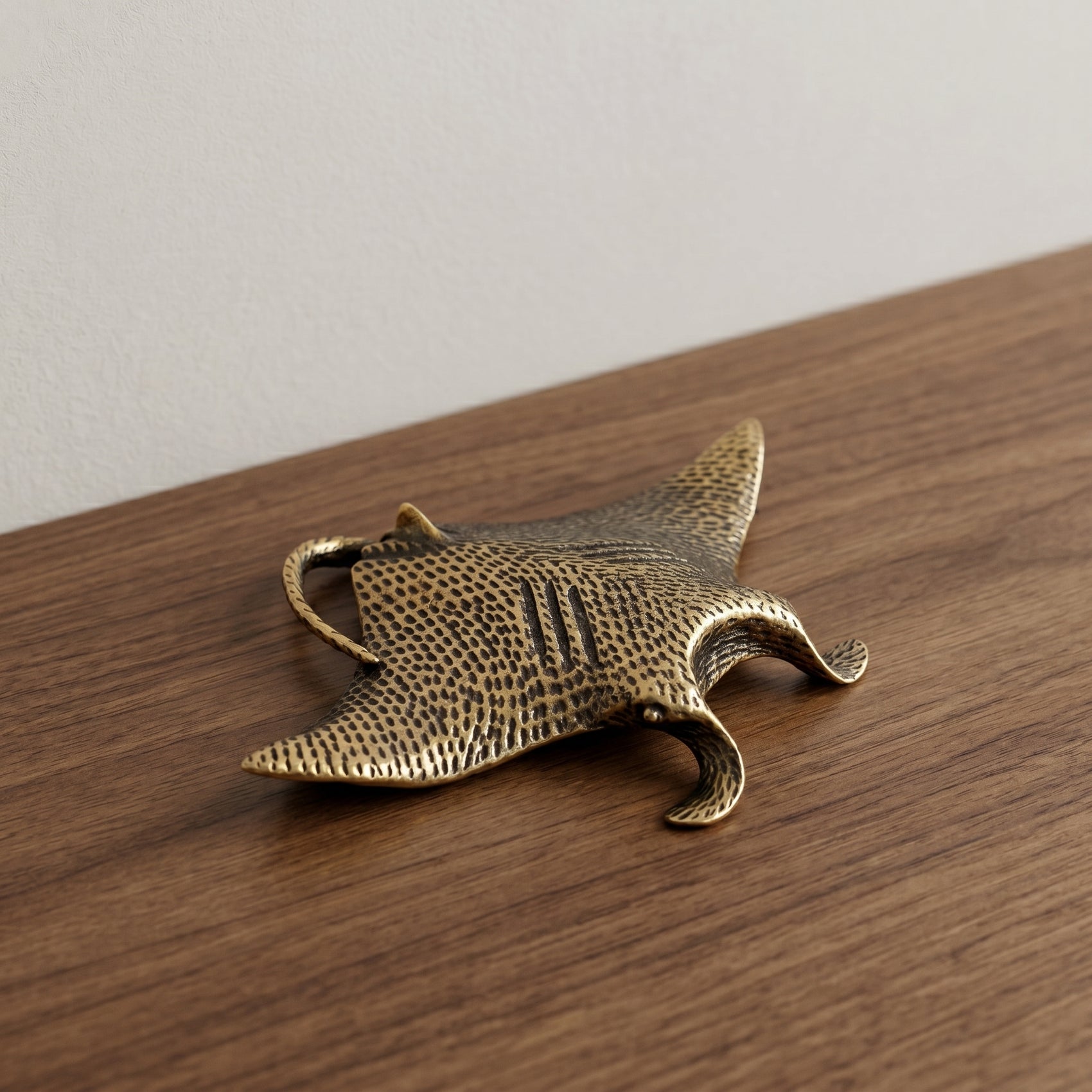 The Drifter miniature solid brass manta ray figurine with finely textured wings and aged antique patina