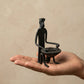 The Drummer Bastar wrought iron sculpture in seated pose holding a drum, hand-forged in Chhattisgarh India, from WILLAGE