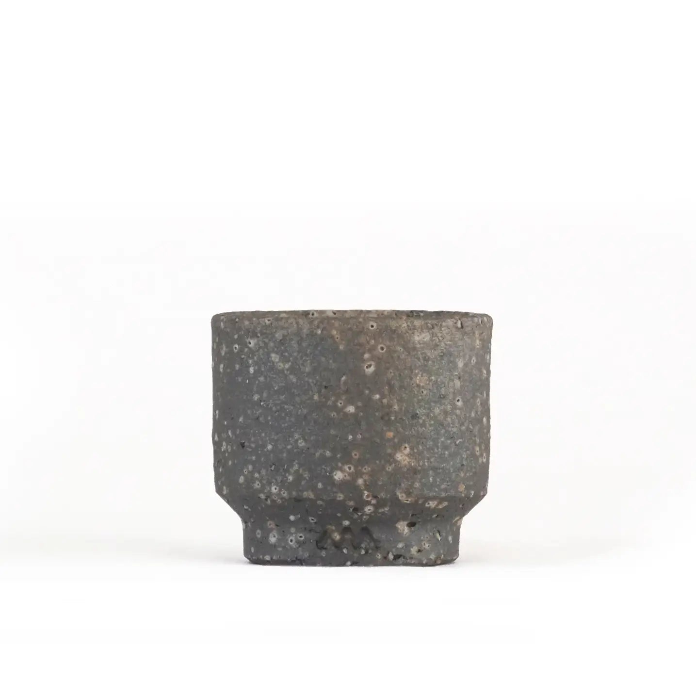 Large and small unglazed Iga ware stoneware cups side by side, showing the two sizes and their dark bronze-flecked surfaces