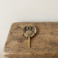 The Eternal Voyager miniature brass horseshoe crab showing underside detail and patina against a neutral background