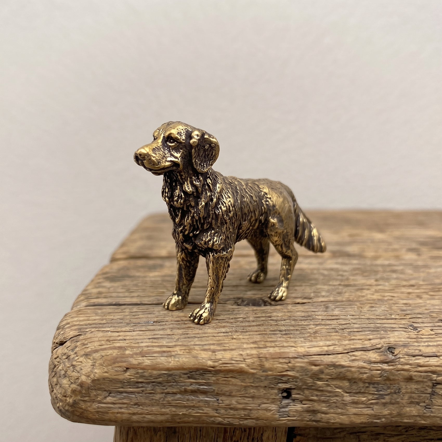 The Faithful miniature solid brass golden retriever figurine with a finely detailed feathered coat and aged antique patina