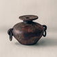 Febi terracotta vessel shown from angle, showing iron ring handles and aged brown finish, from Indonesia