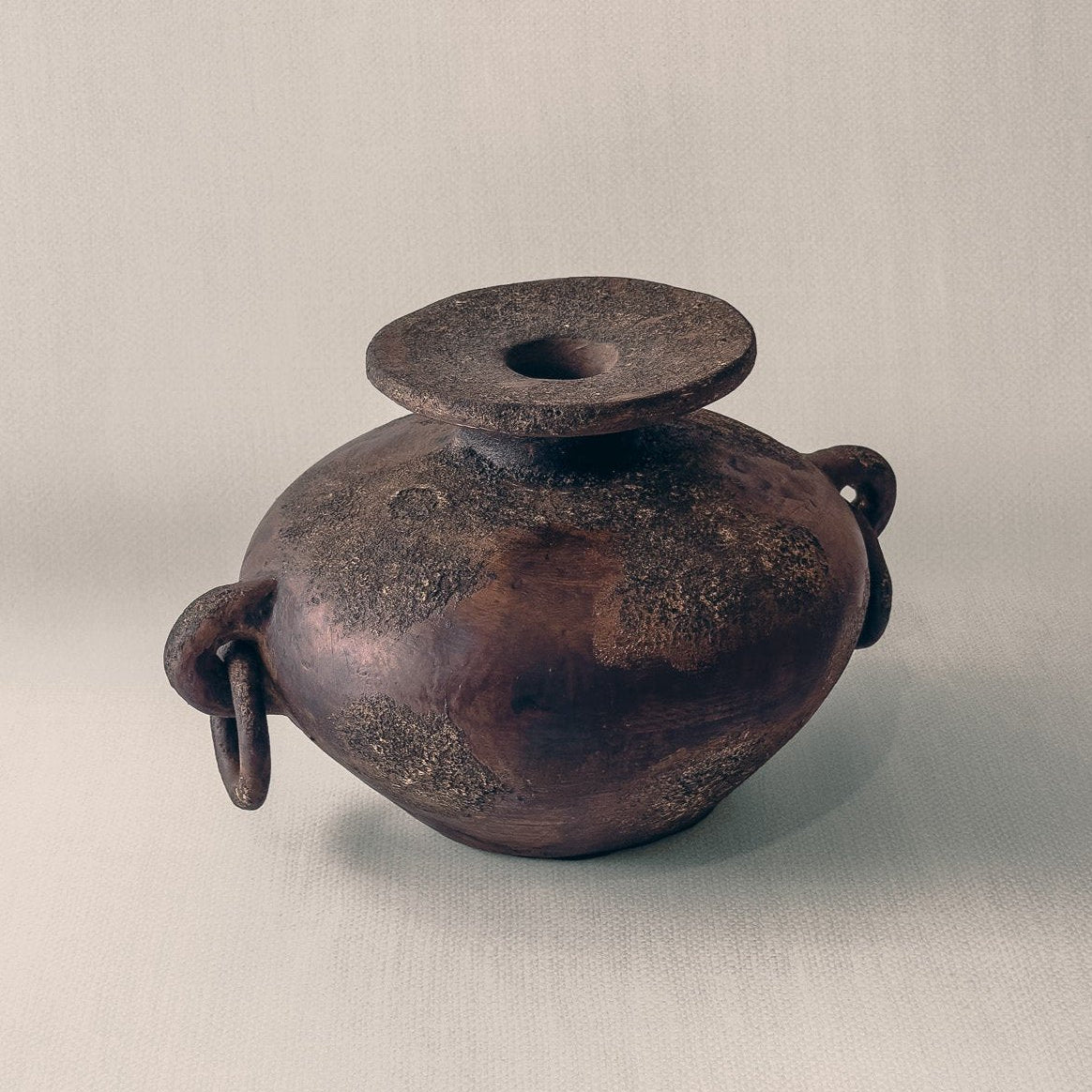 Indonesian handcrafted terracotta vessel with sculptural handles, shown on neutral background, from WILLAGE