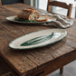 Hand-painted earthenware fish serving platter from Club Bonheur Belgium, styled on rustic wood table with fresh bread, from WILLAGE