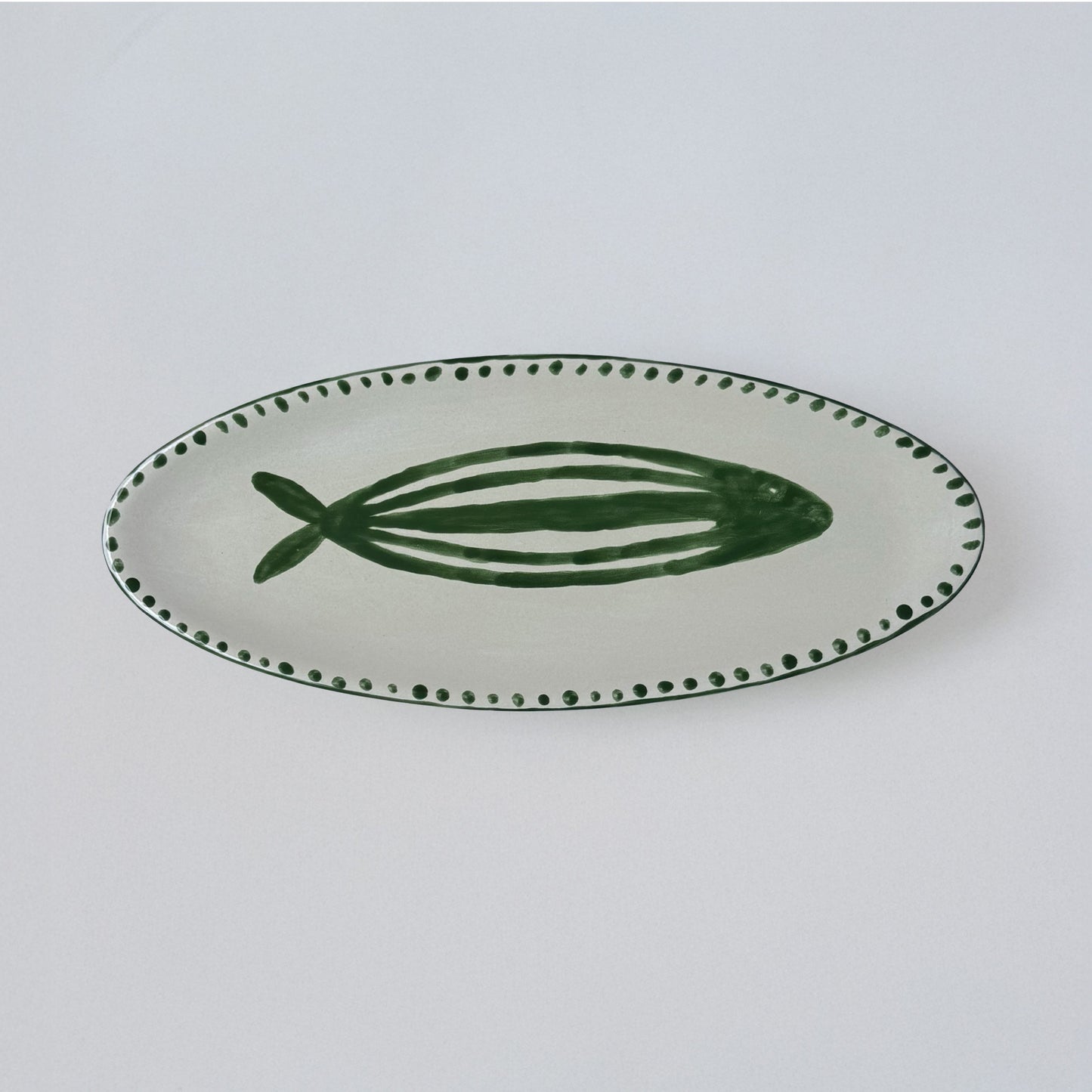 Green and red striped fish-shaped earthenware serving platter, hand-shaped and hand-painted by Club Bonheur in Belgium