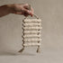 The Gathered Earth Wall Hanging with seven horizontal clay rungs showing raw unglazed texture and mineral variations, hand-built by Conrad and Dina in Canada, from WILLAGE
