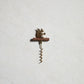 The Gilded Corkscrew showing sculptural animal handle detail and gold aluminum finish against a neutral background