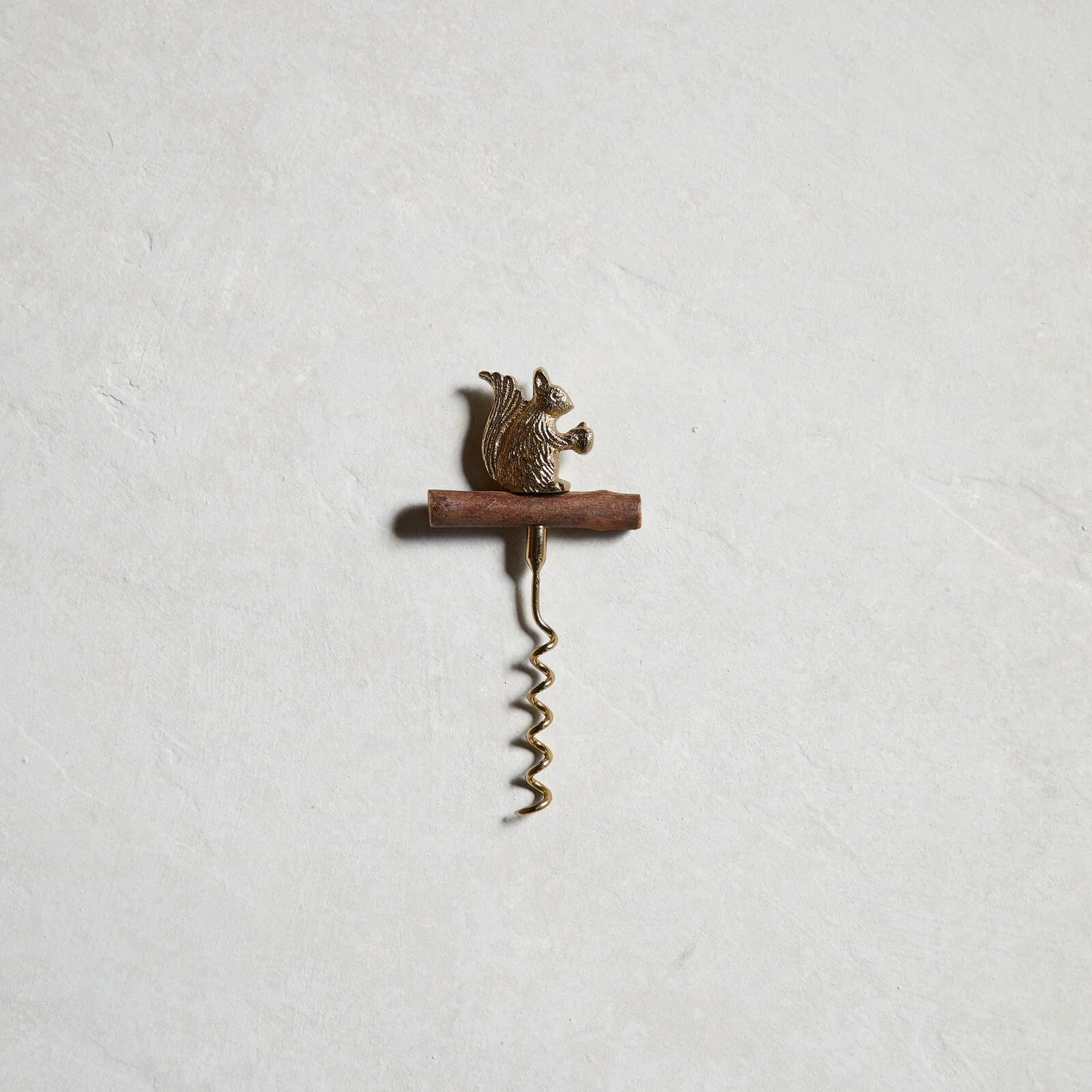 The Gilded Corkscrew showing sculptural animal handle detail and gold aluminum finish against a neutral background