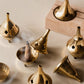 Golden brass incense burners showing removable lid, hand-cut apertures, and warm brass finish from multiple angles