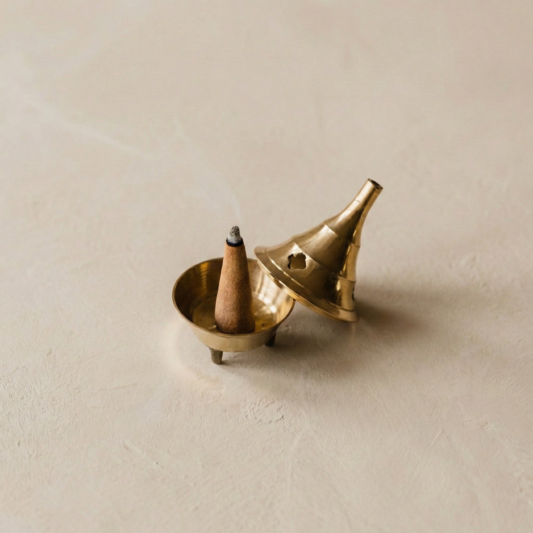 Golden brass cone incense burner with removable lid and hand-cut smoke holes, handcrafted in the Netherlands, from WILLAGE