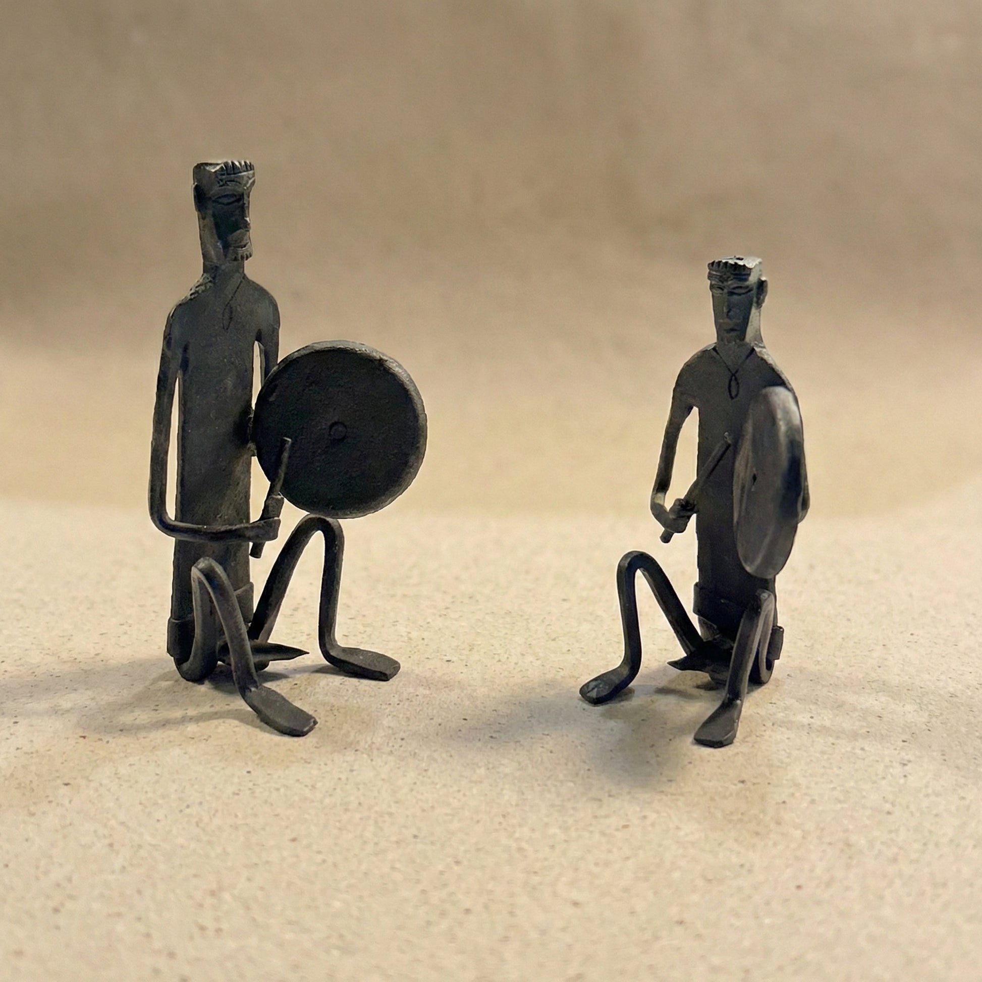 The Gong Players Bastar wrought iron sculpture pair showing two hand-forged figures holding gongs, handcrafted in Chhattisgarh India, from WILLAGE