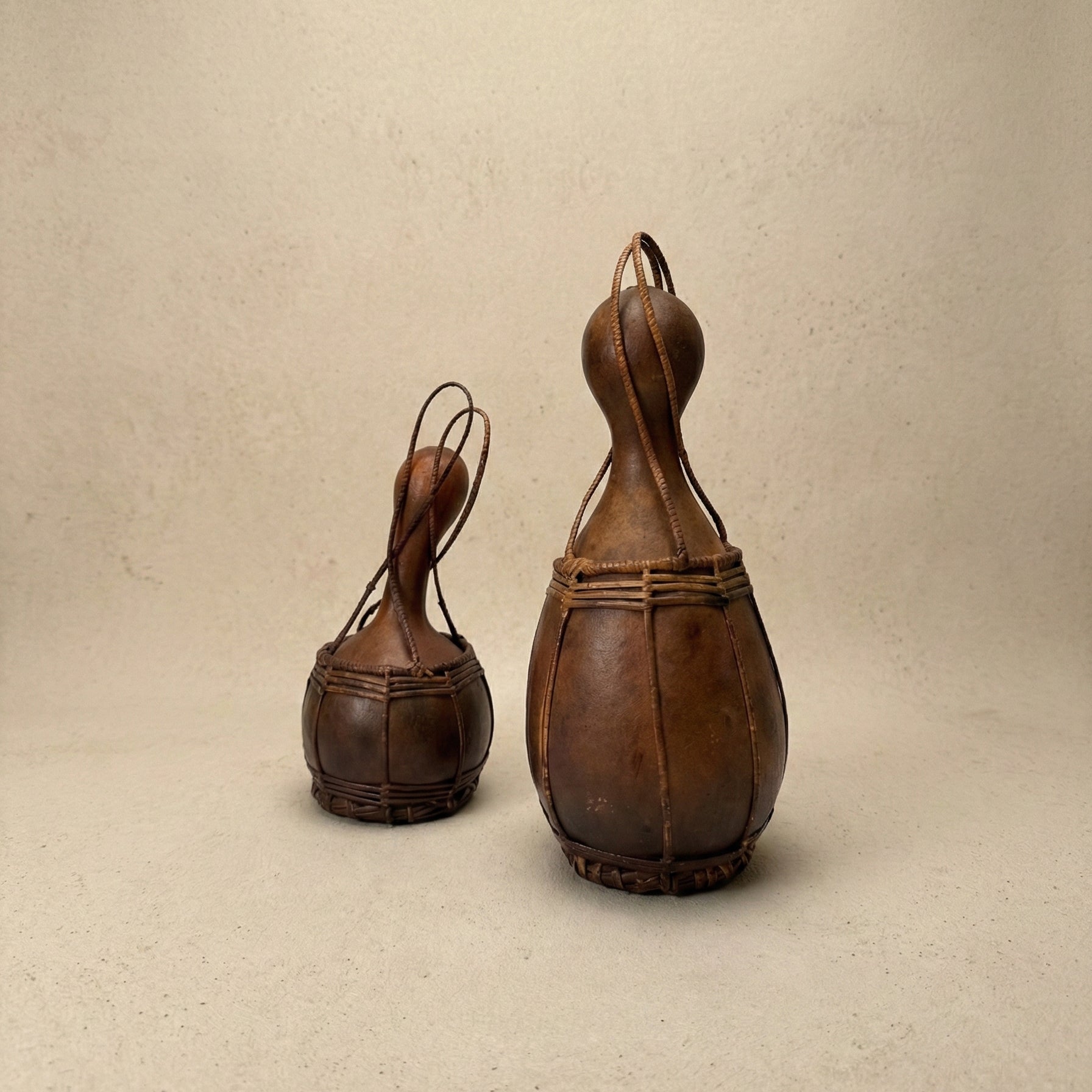 Close-up of the Grand A·chik Canteen showing hand-split rattan weave pattern binding the cured forest gourd