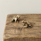 he Harmonic Herald miniature solid brass frog pair on natural wood block showing aged patina detail