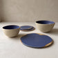 Handmade stoneware bowls arranged on a table setting