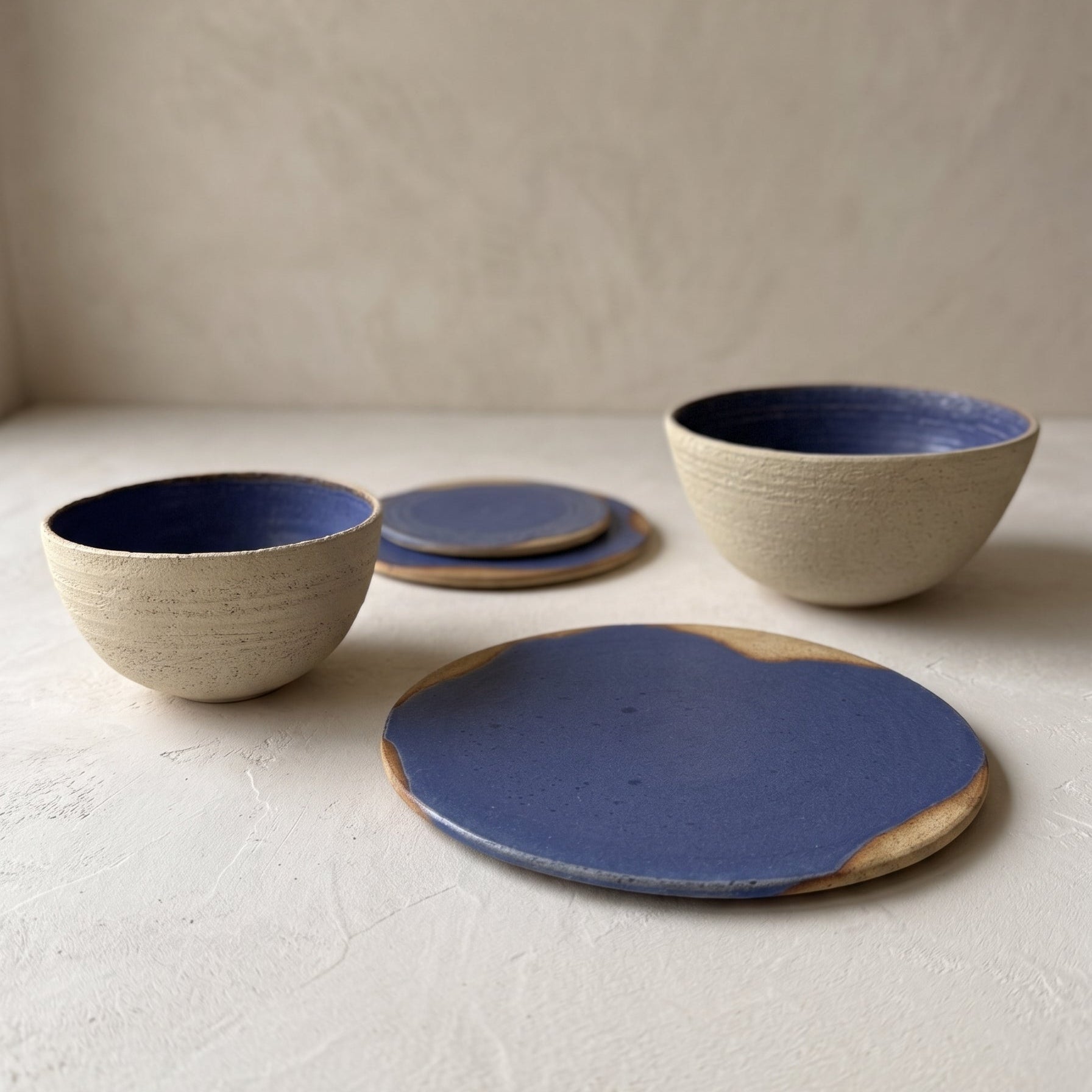 Handmade stoneware bowls arranged on a table setting