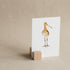 Hold It beech wood photo and card stand displaying a postcard print, showing natural wood grain and precise card slot, handcrafted in the Netherlands, from WILLAGE