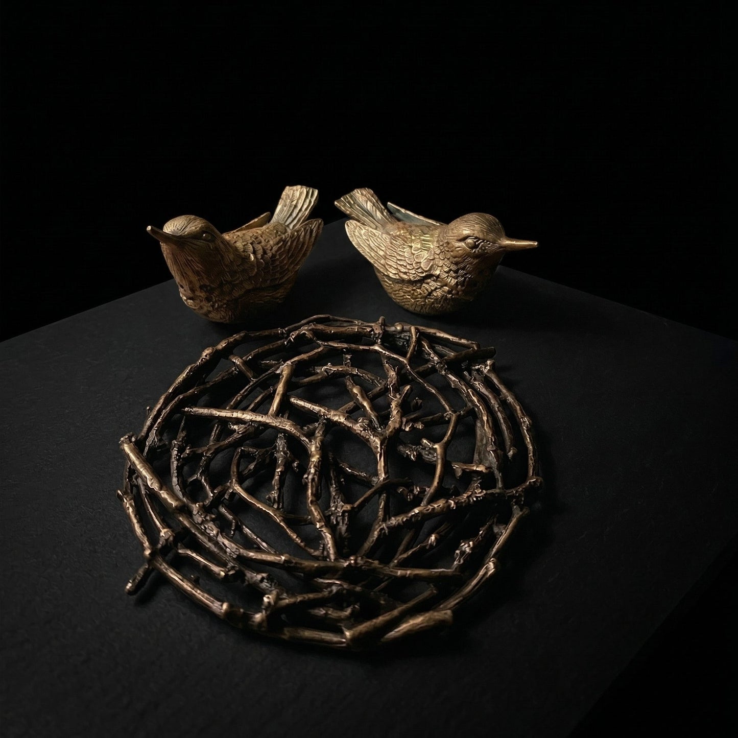 Hummingbird salt and pepper set deconstructed showing two cast pewter bird vessels and woven branch nest tray