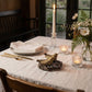 Hummingbird pewter salt and pepper nest tray as table centerpiece with linen tablecloth candles and flowers