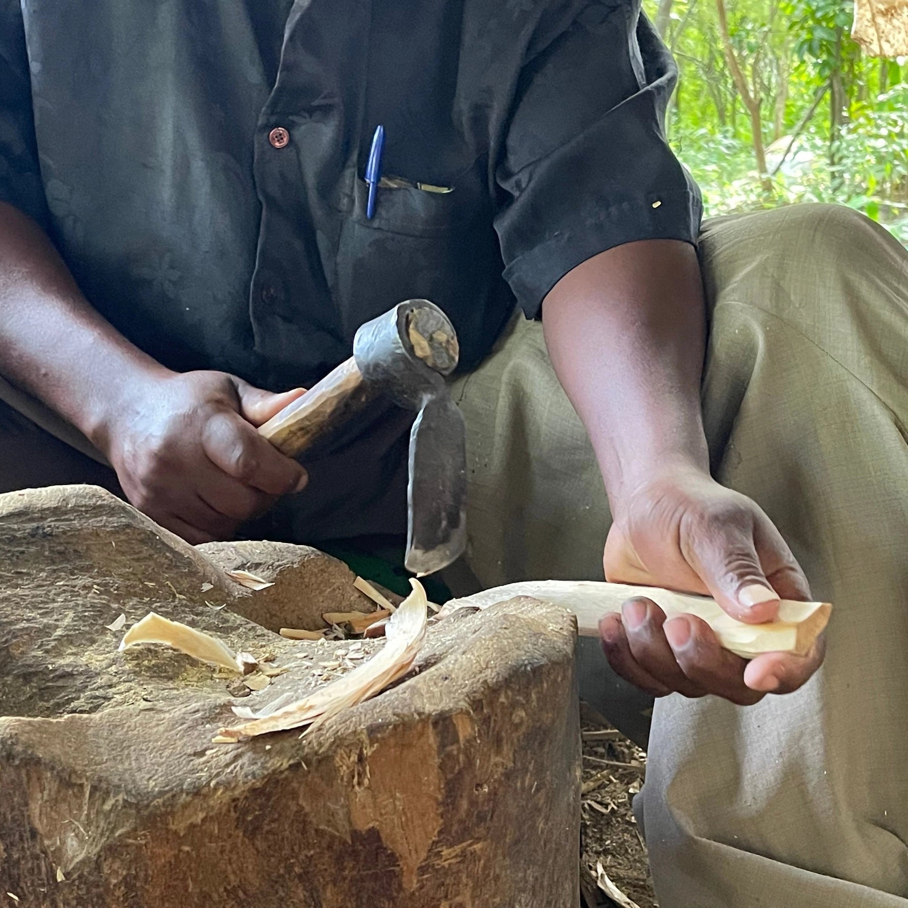 Kamba Tribe artisan hand-carving wood sculpture using traditional tools in Machakos Kenya