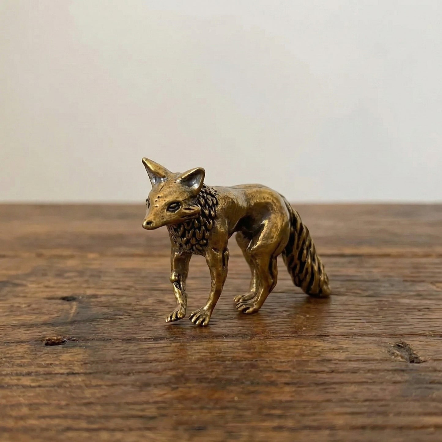 The Keen Fox miniature brass fox figurine in crouched alert pose with head lowered, solid brass with aged patina, from WILLAGE Tiny Objects collection