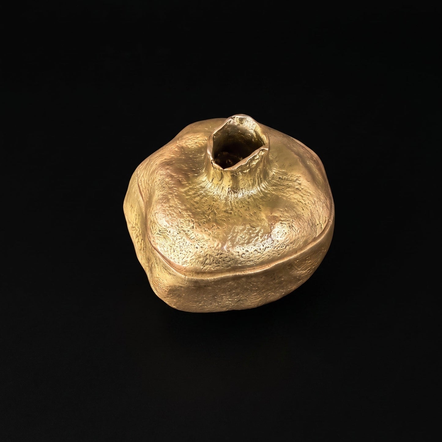 Pewter pomegranate keepsake box with antique brass finish, lid removed to show the smooth hollow interior
