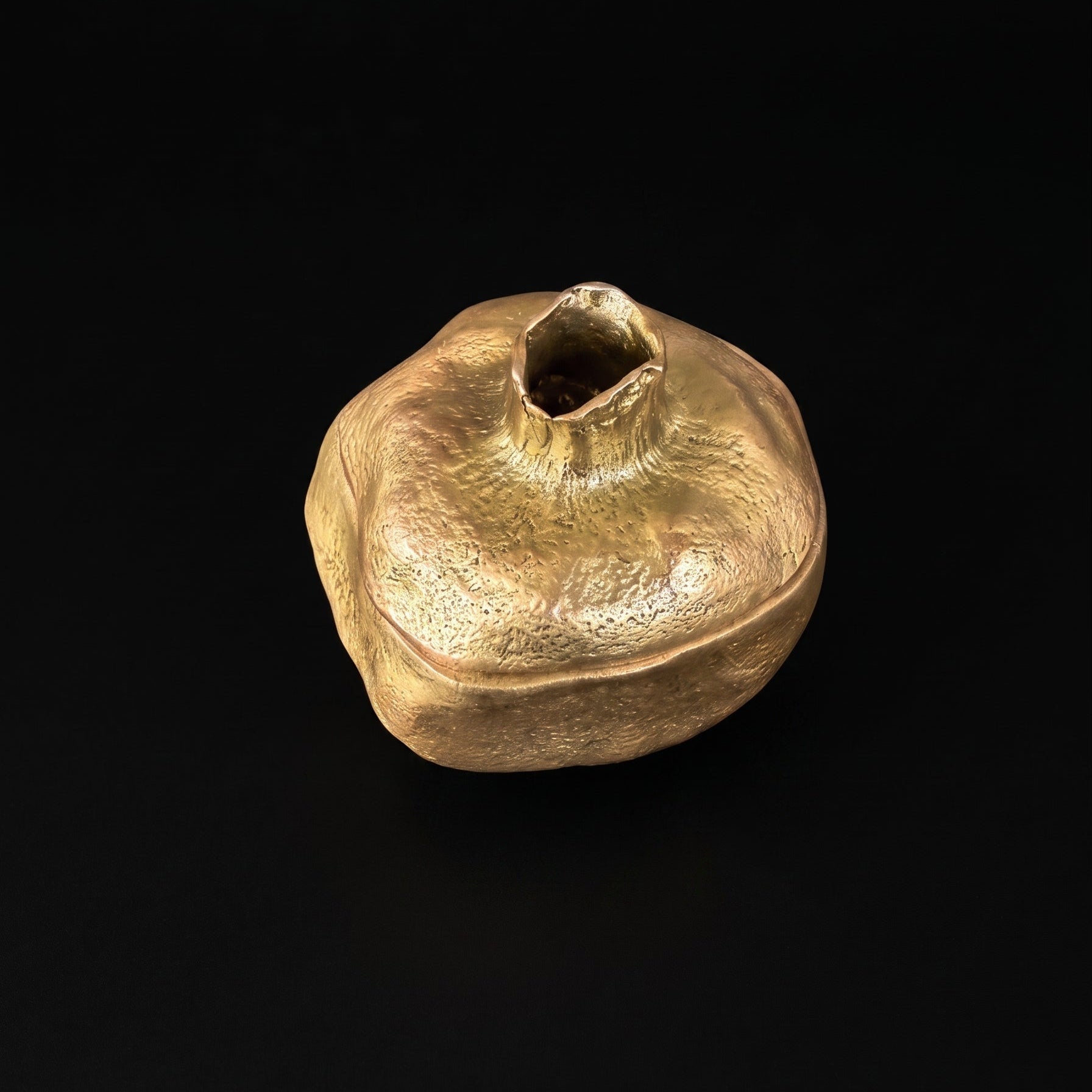 Pewter pomegranate keepsake box with antique brass finish, lid removed to show the smooth hollow interior