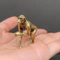  Small brass ape figurine walking on knuckles, held in an open palm to show its size and antique patina