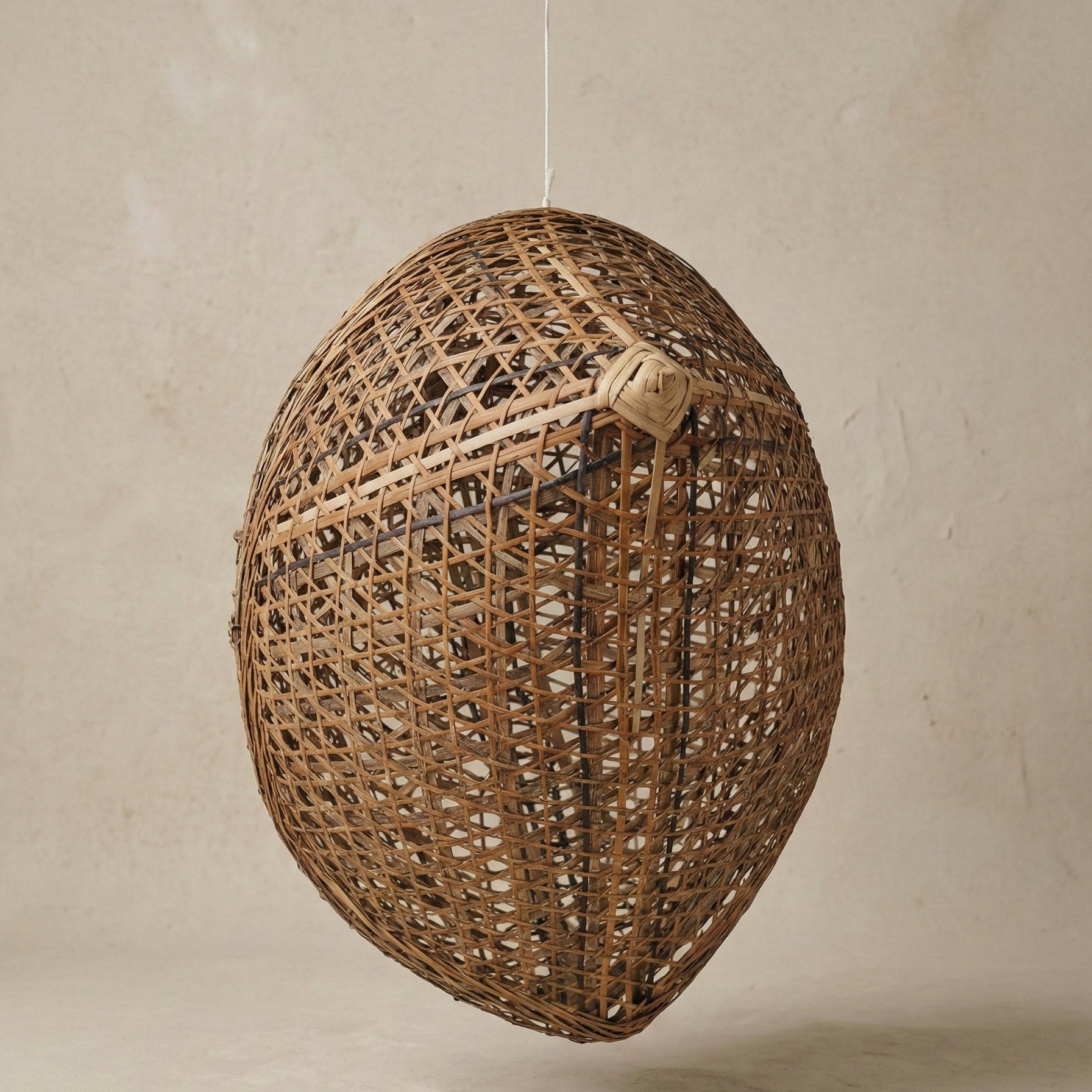 The Knup bamboo lampshade close-up showing interlocking weave pattern and natural bamboo tone